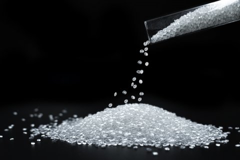 Close-up of plastic polymer granules and plastic beads.