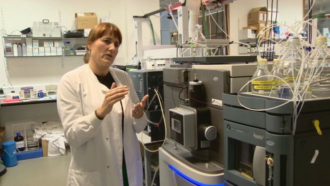 Dr. Perdita Barran, of The University of Manchester, stood in a laboratory, explaining the use of mass spectrometry in identifying the biomarkers of Parkinson's disease.