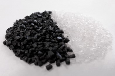 A pile of many black and translucent shards of biodegradable plastic.