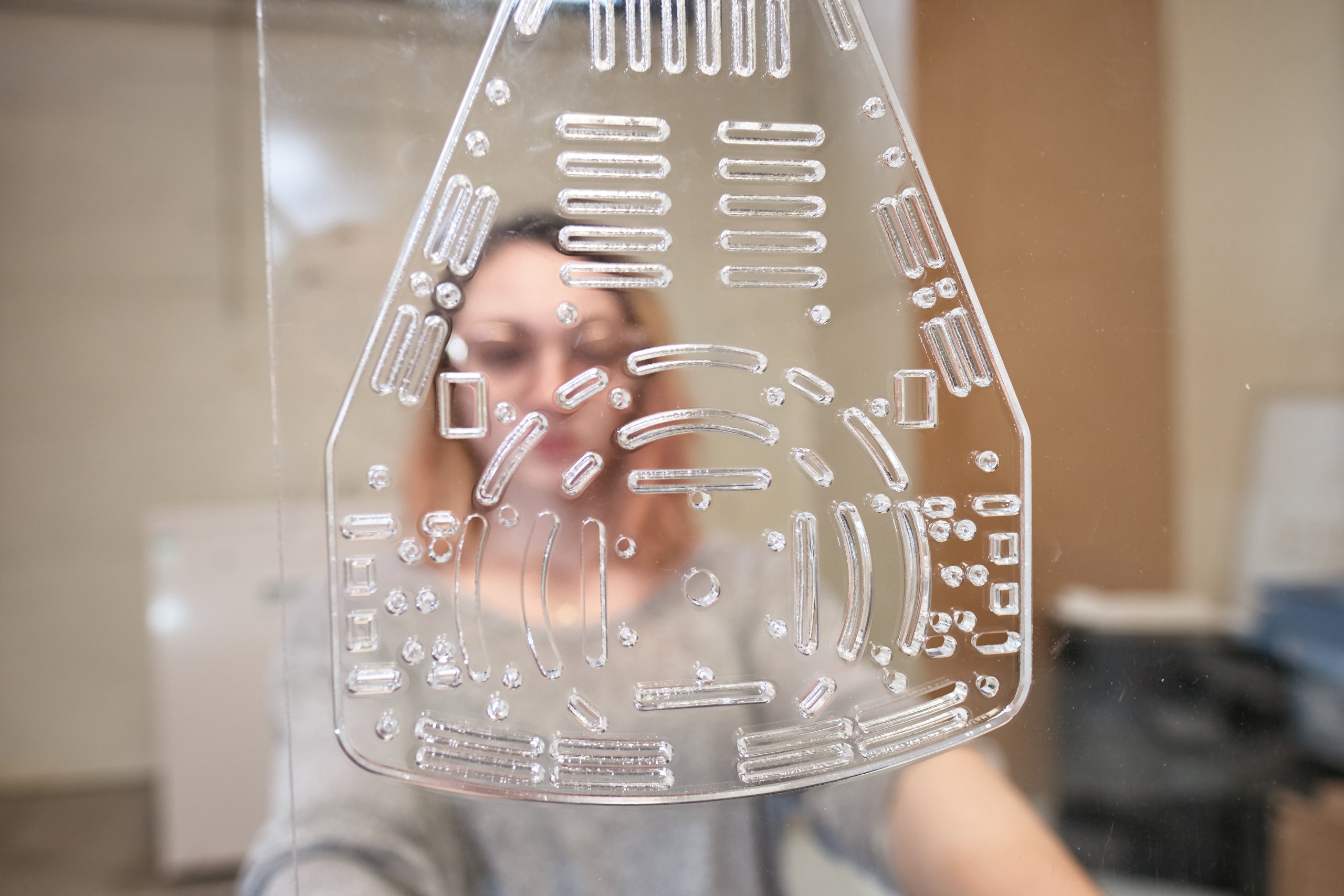 Photo of a laser-cut Perspex piece of the Puzzlebot, Innovation Factory - Manchester University