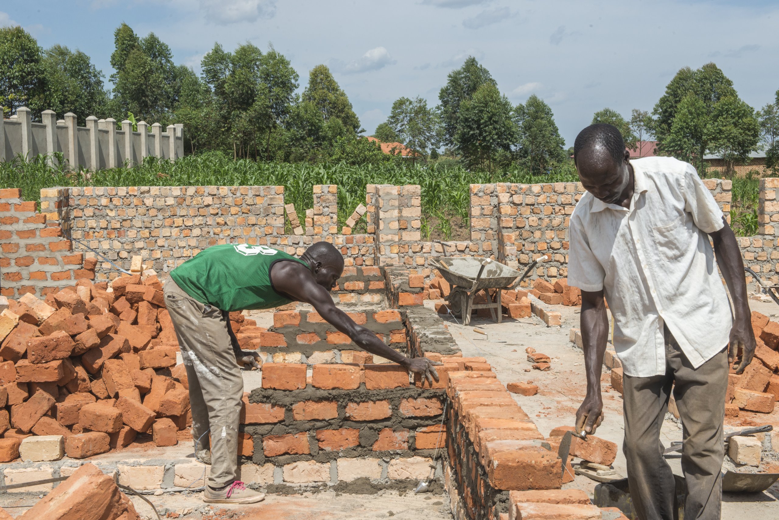 Andrew Amara working on building a brick wall.