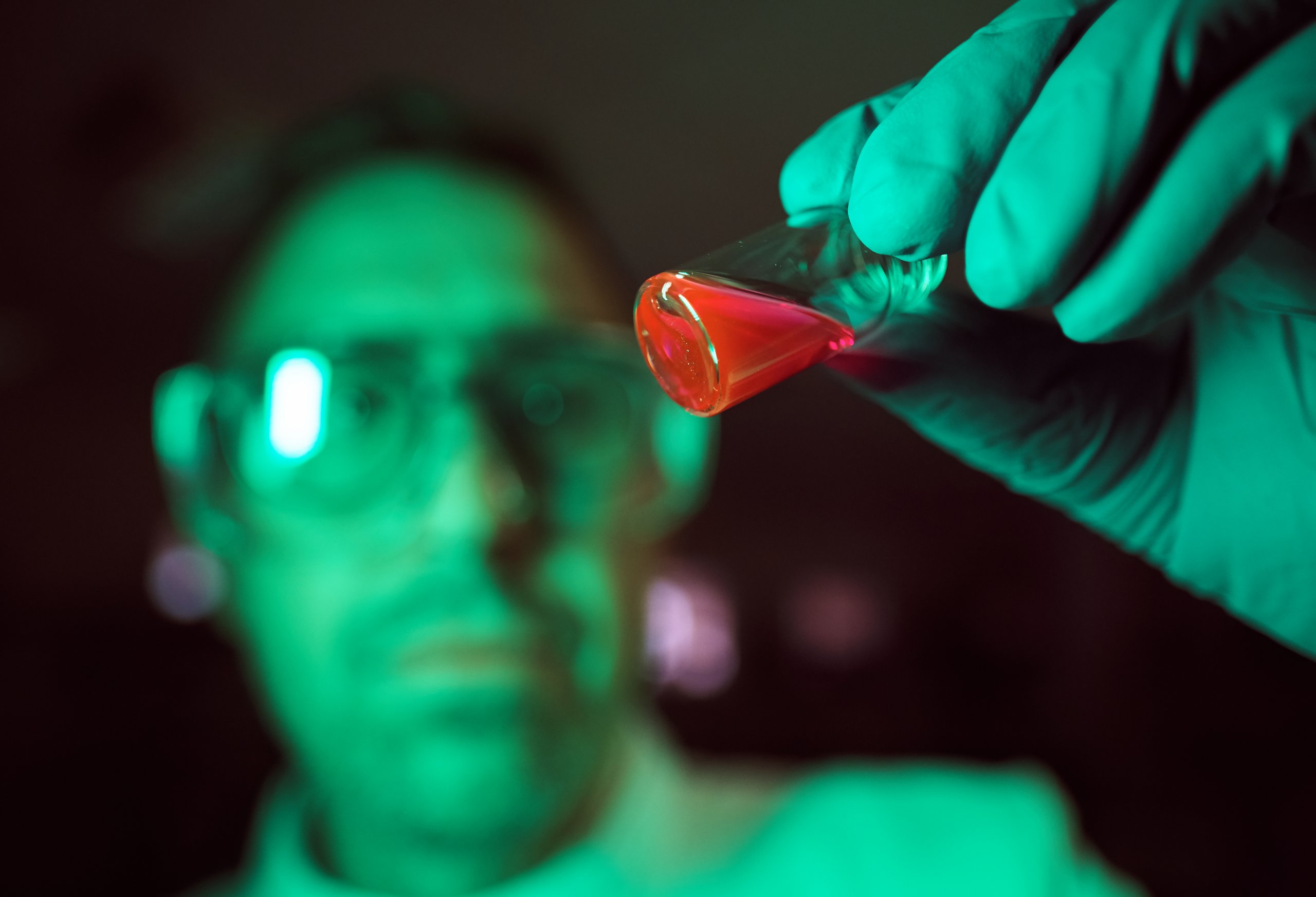 Scientist with a vial of substance being analyzed
