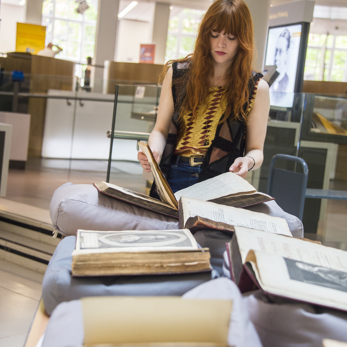 A woman reading books in a laboratory