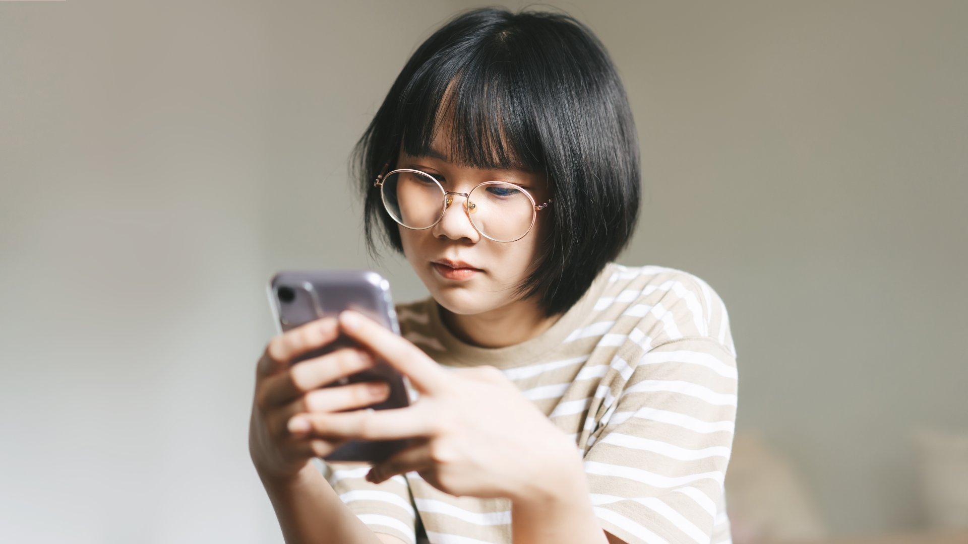 Young female adult using app on phone for mental health