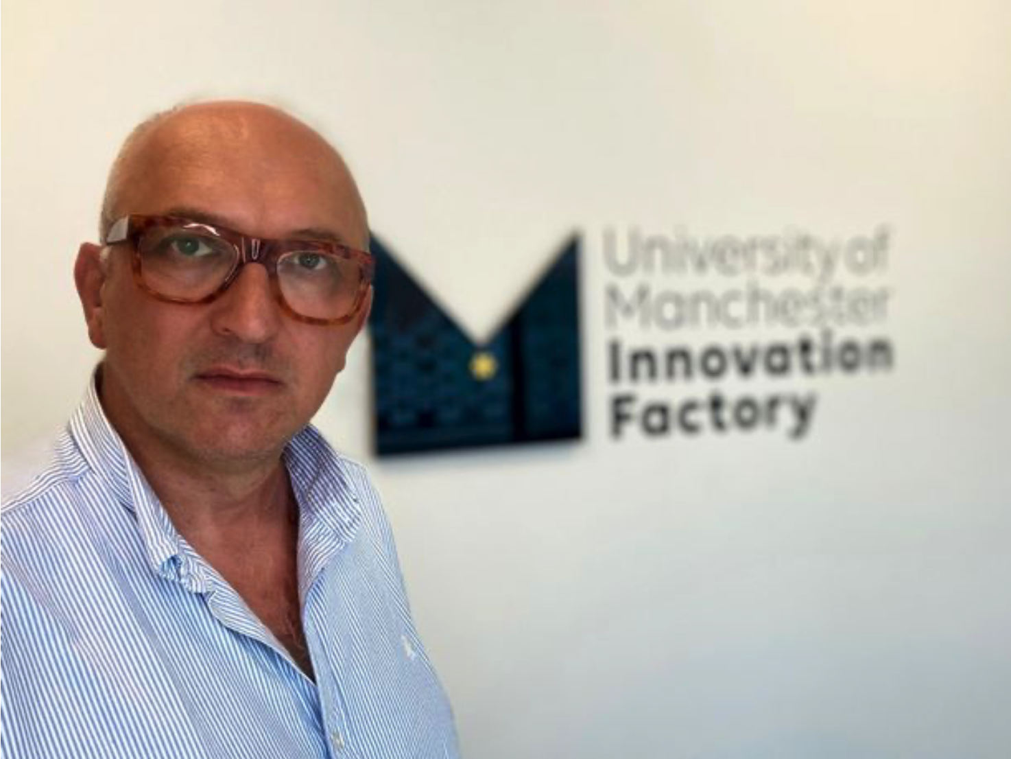Andrew Wilkinson, withUoM Innovation Factory logo behind him