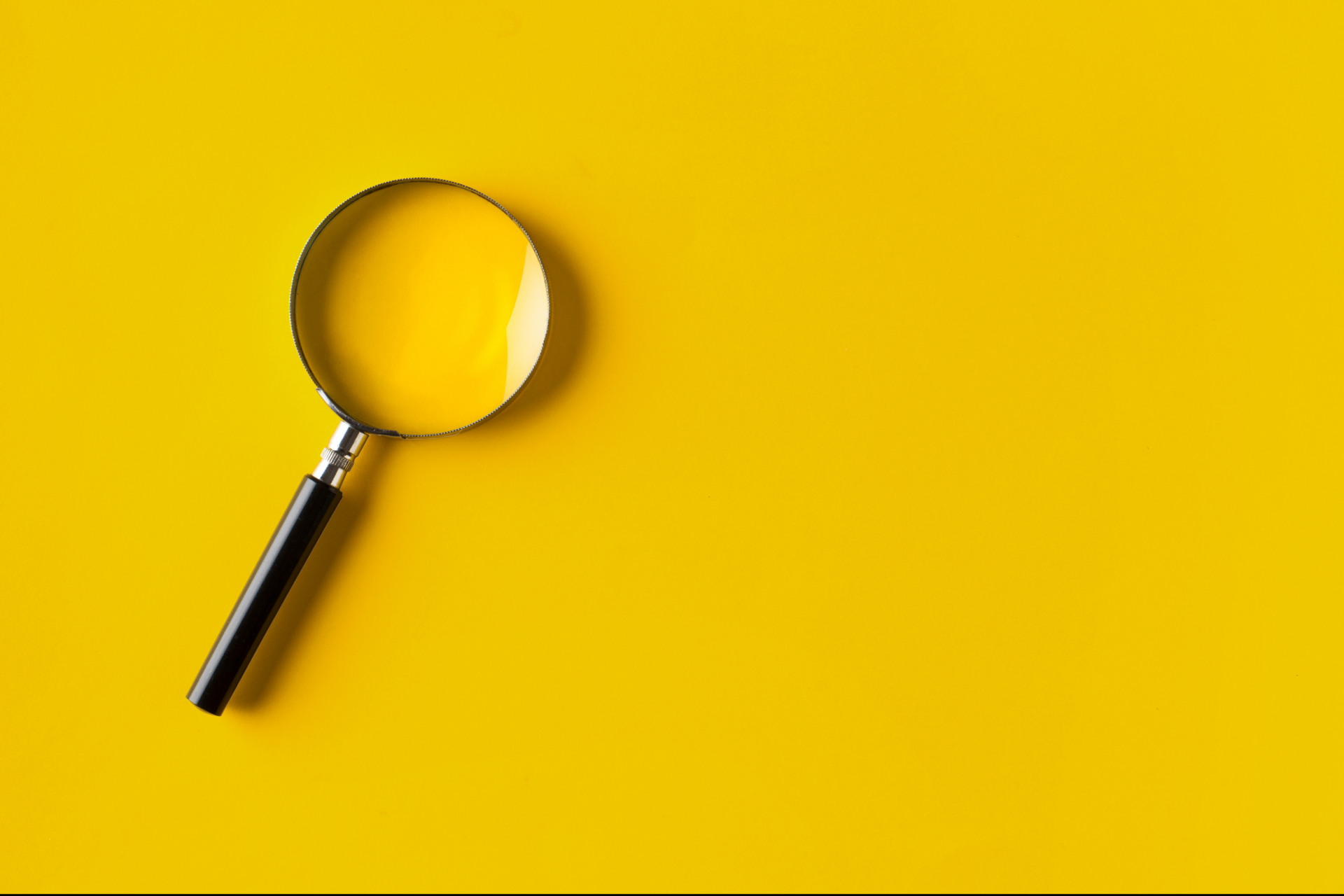 Magnifying glass on yellow background