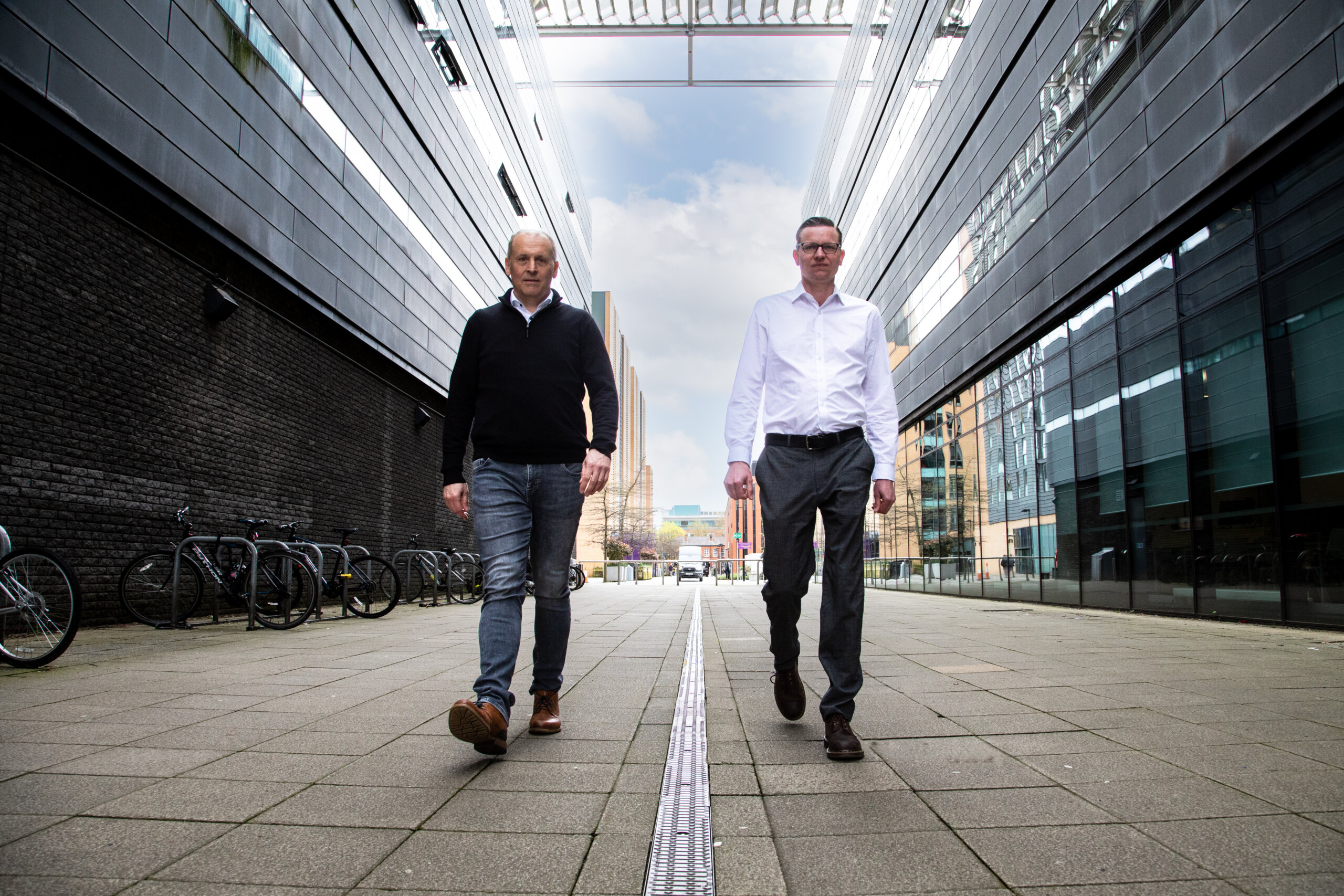 Photo showing two men walking towards camera in street: CEO, Paul Khan (left) and Founder and CTO, Tim Echtermeyer (right)