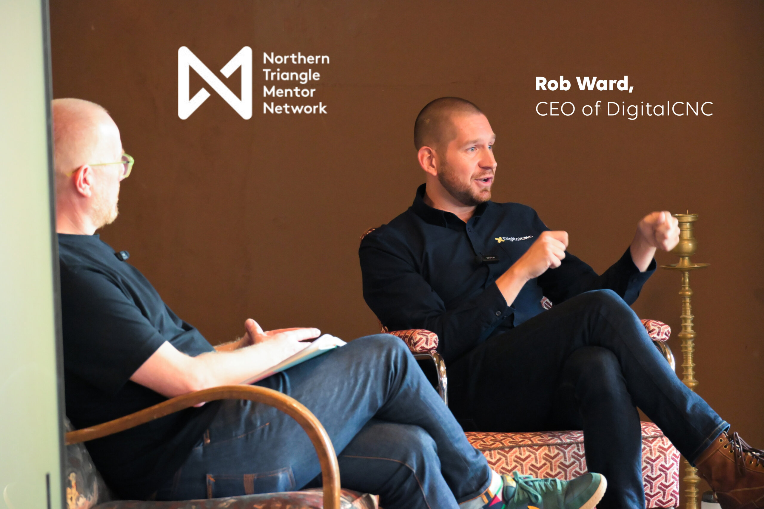 two men sitting on chairs talking with Northern Triangle Mentor Network logo and title "Rob Ward, CEO of DigitalCNC"