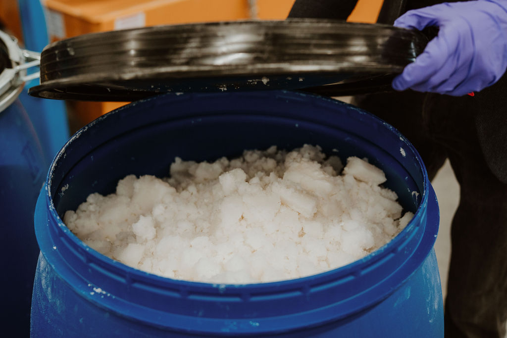 a large blue bucket of extracted lithium